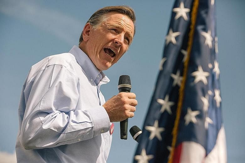 Republican Paul Gosar (left) is expected to retain his seat despite a series of ads by his Democrat opponent, Mr David Brill, featuring six of the congressman's nine siblings.