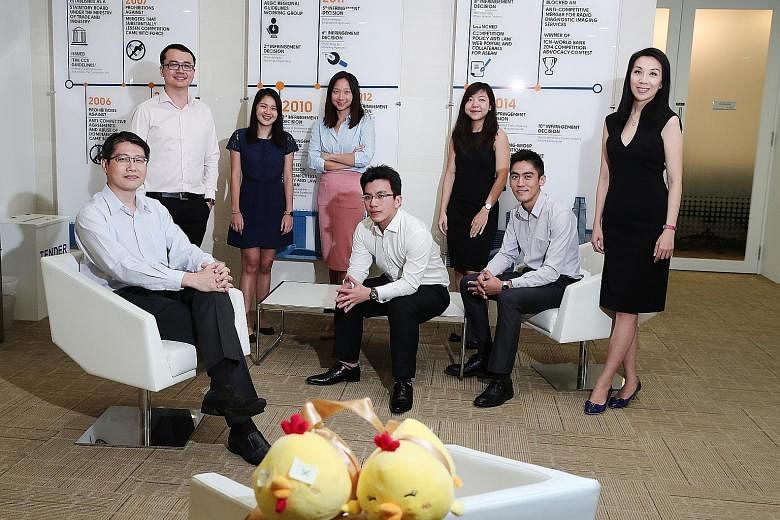 (From left) Team leader Kong Weng Loong, deputy director of the CCCS' business and economics division, with team members Lim Wei Lu, Sarah Tan, Ethel Lin, Tham Chang Xian, Janet Chua, Nicholas Sim and Lee Wan Yi, who worked on the price-fixing case. 