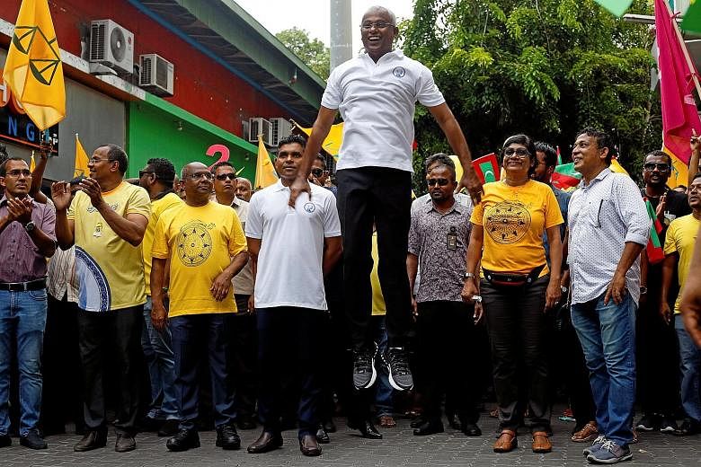Mr Ibrahim Mohamed Solih of the Maldivian Democratic Party in an exuberant moment during campaigning in the Maldives' presidential election last week. The opposition candidate on Sunday won the election and the current president has conceded defeat a
