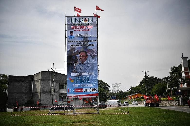 A poster in Port Dickson with Datuk Seri Anwar Ibrahim's image. Mr Anwar is expected to win the by-election easily, but Umno president Ahmad Zahid Hamidi said Barisan Nasional viewed the seat as being vacated "to fulfil the political ambitions of one