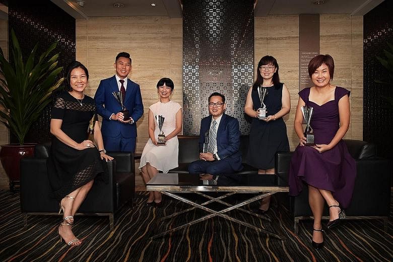 SPH staff who received awards at the Sias Investors' Choice Awards: (from left) Business Times senior correspondent Angela Tan; Lianhe Zaobao business correspondent Wong Kang Wei; Lianhe Zaobao correspondent Tang Ai Wei; chief financial officer Chua 