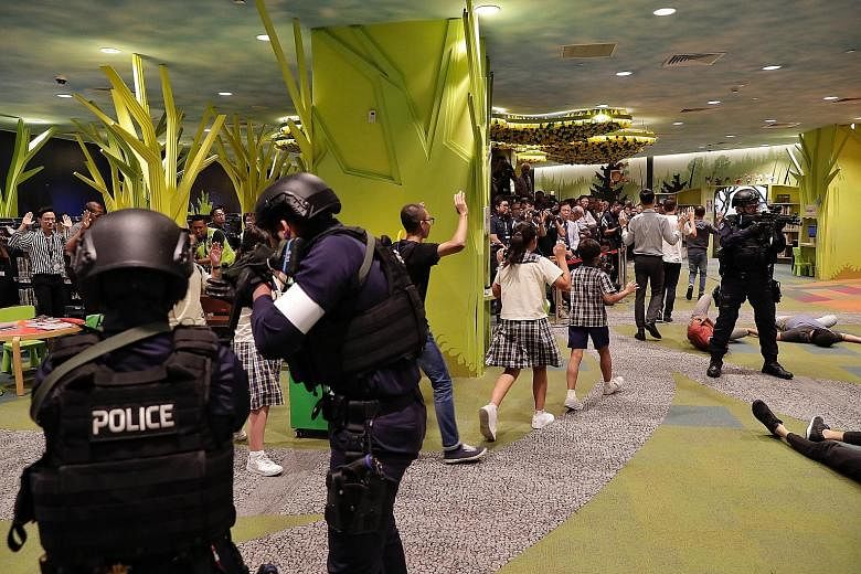 Police ushering library users to safety during anti-terror drill Exercise Heartbeat at the National Library Building yesterday. In analysing a survey from last year of just over 2,000 Singaporeans, researchers also found that older and less well-off 