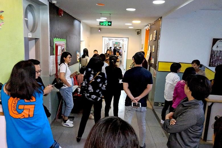 About 30 parents turned up at the Beijing BISS International School yesterday demanding answers after the teachers refused to work last week.