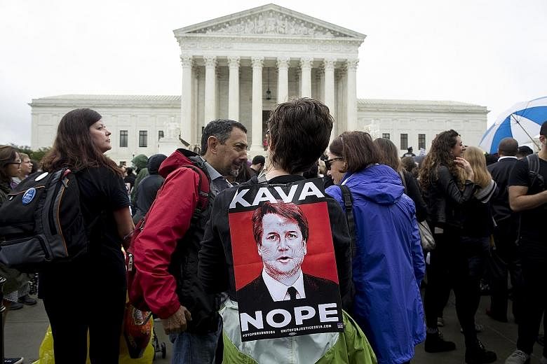 Protesters demonstrating against Mr Brett Kavanaugh's nomination to America's highest court outside the Supreme Court on Capitol Hill in Washington on Monday.