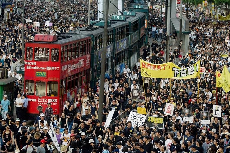 People taking to the streets of Hong Kong in July 2003 to protest against the implementation of Article 23, a controversial anti-subversion law.