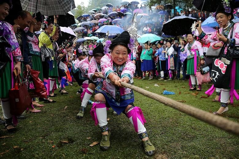 Ethnic Miao women taking part in a tug of war on Thursday to celebrate a local festival in the Rongshui Miao autonomous county of southern China's Guangxi Zhuang autonomous region. The festival, known as "Bohui", takes place twice a year on a mountai