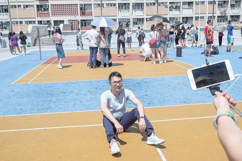 It is difficult to start a game of basketball in Choi Hung Estate, with visitors standing or sitting on the courts for photos.