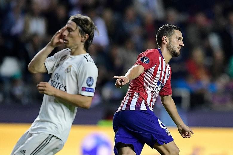 Koke celebrates scoring a goal to seal Atletico's 4-2 extra-time win in the Uefa Super Cup last month as Real Madrid's Luka Modric shows his anguish.