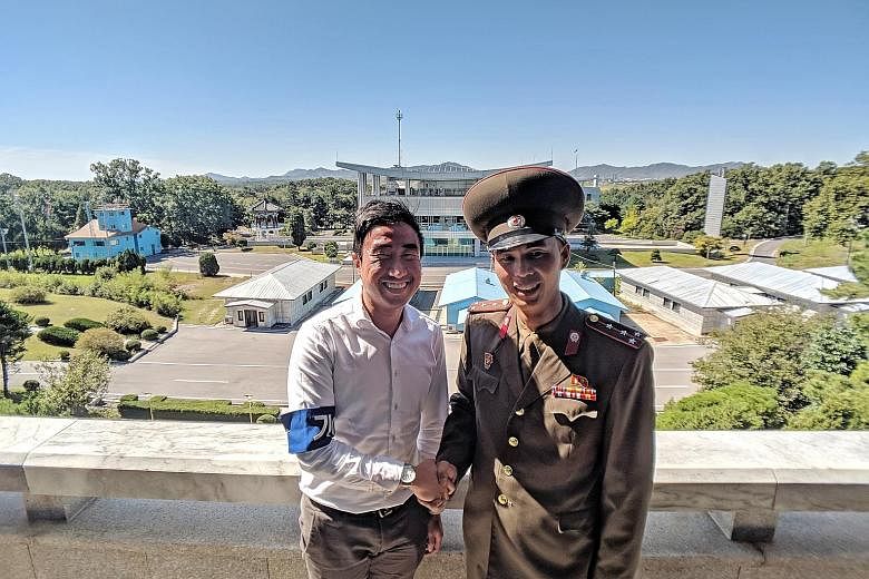 ST correspondent Walter Sim with Captain Han Guk Chol, who asked for a photo on learning Mr Sim is a Singapore journalist who covered the Panmunjom summit in April.