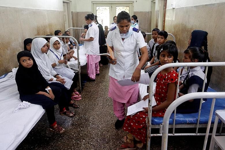 Patients at a hospital in Mumbai. Critics of a new government health insurance scheme say it is underfunded and overlooks India's grossly inadequate public health infrastructure.