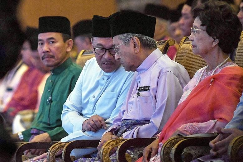 Parti Keadilan Rakyat president-elect Anwar Ibrahim chatting with Malaysian Prime Minister Mahathir Mohamad at the Future of the Bumiputera and Nation Congress 2018 in Kuala Lumpur last month. Beside them is Tun Dr Mahathir's wife Siti Hasmah Mohamad