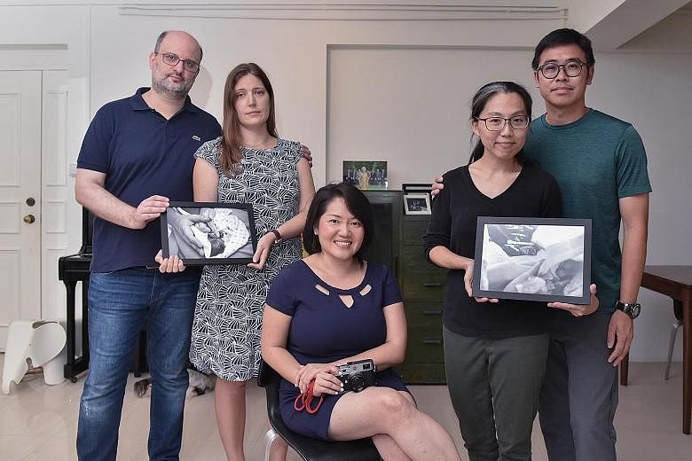 Photographer Joan Leong with couples Peter and Victoria Taylor, and Lim Li Fern and Wong Yong Jie, who are holding portraits of their babies. More parents have approached her in the last two years.