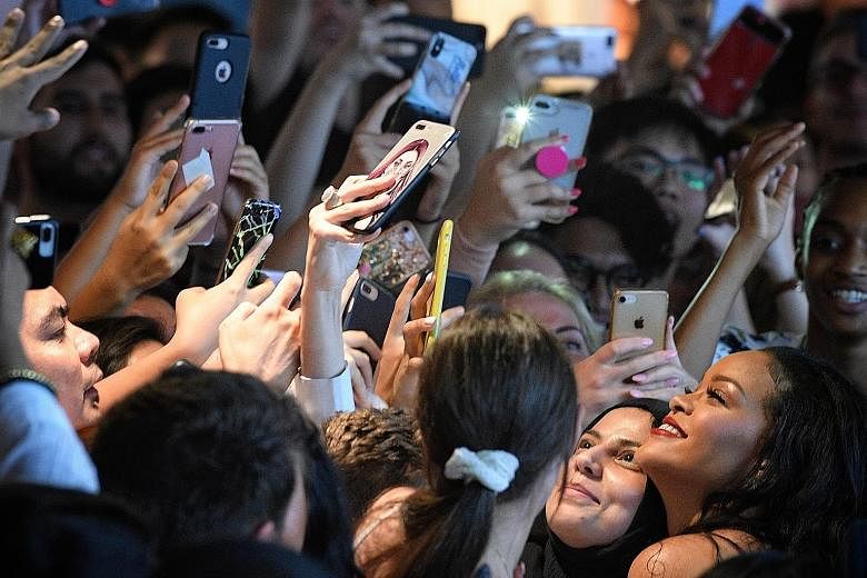 Pop star Rihanna posing for selfies with fans at Sephora ION last night. The founder of Fenty Beauty was celebrating the first anniversary of her brand.