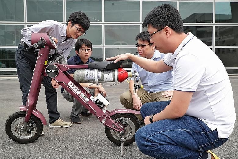 Above: A hydrogen fuel cell drone at Temasek Polytechnic. (From far left) Temasek Polytechnic's lead for the Shell Eco Marathon Wang Lei, Duralite Power research and development engineer Tan Meng Seng, Duralite general manager Ling Chun Yu and Durali