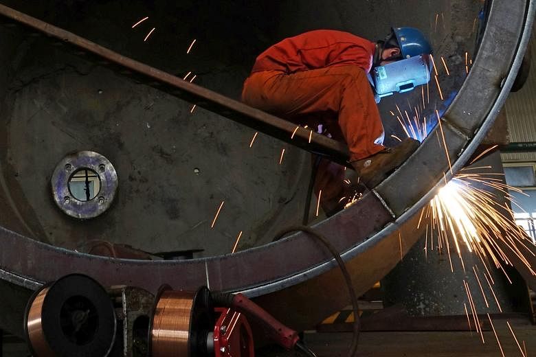 A steel worker at a plant in Dalian, Liaoning province. Two surveys from China on Sunday pointed to weakening in its manufacturing sector as domestic demand falters and US tariffs bite.
