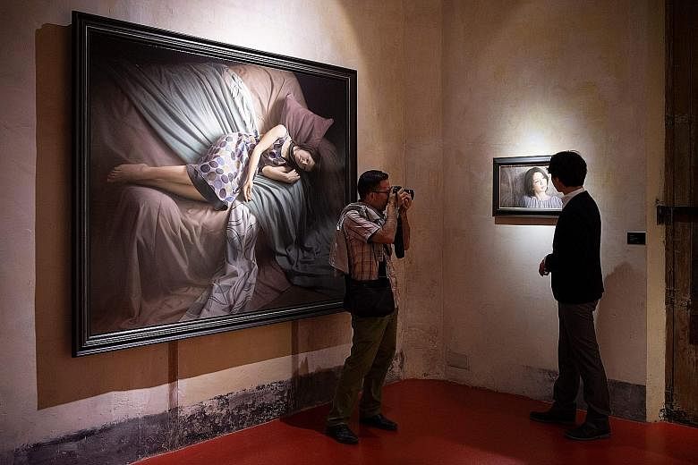 A visitor taking a photo at the exhibition, Contemporary Japanese Realism, at the European Museum of Modern Art in Barcelona last month.