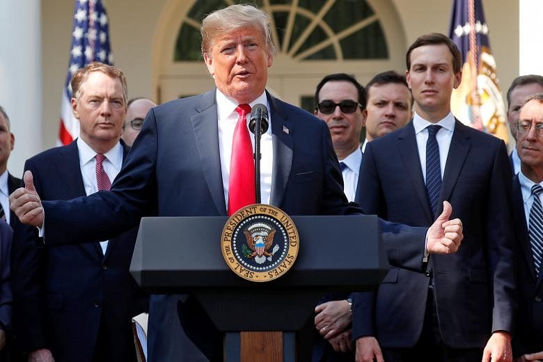 President Donald Trump announcing the new United States-Mexico-Canada Agreement at a news conference in the Rose Garden of the White House on Monday. Flanking him are US Trade Representative Robert Lighthizer (left) and White House senior adviser Jar