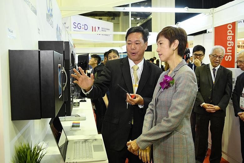 Second Minister for Home Affairs Josephine Teo with uberGARD's general manager Tim Koh at the opening of the Security Industry Conference yesterday. Mrs Teo said there is also a need to move away from an "output-based" contracting model, where buyers