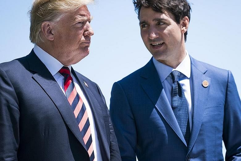 Canadian Prime Minister Justin Trudeau (right) talking with US President Donald Trump during a welcome ceremony at the G-7 summit meeting in June last year. The two leaders clashed during the summit. Dairy cows at a farm in Saint-Valerien-de-Milton, 