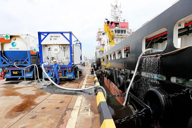 A truck-to-ship liquefied natural gas (LNG) bunkering at Jurong Port. The Maritime and Port Authority of Singapore co-funded the building of eight LNG-fuelled vessels to kick-start the use of the gas as a marine fuel.