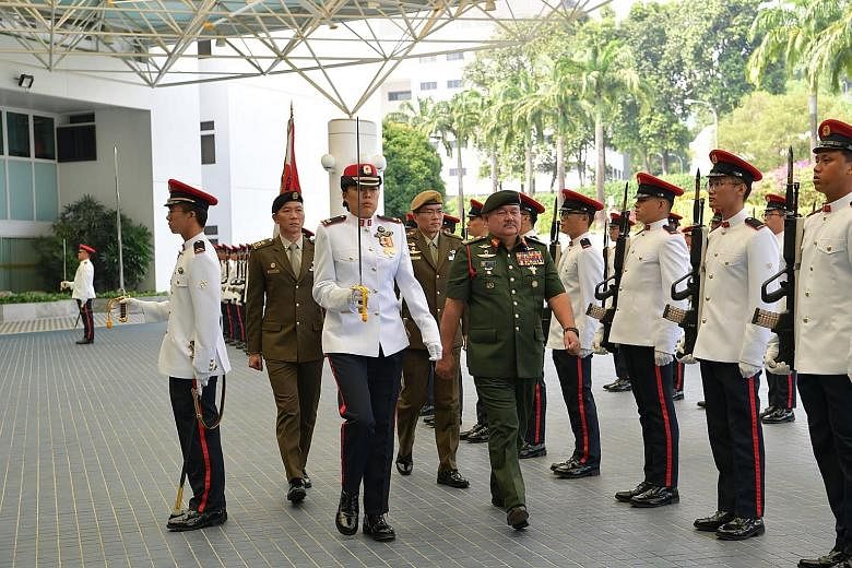 Above: Malaysia's Deputy Minister for Defence Liew Chin Tong (left) meeting Defence Minister Ng Eng Hen at the Ministry of Defence yesterday. Right: General Tan Sri Zulkifli Zainal Abidin reviewing the guard of honour at Mindef yesterday.