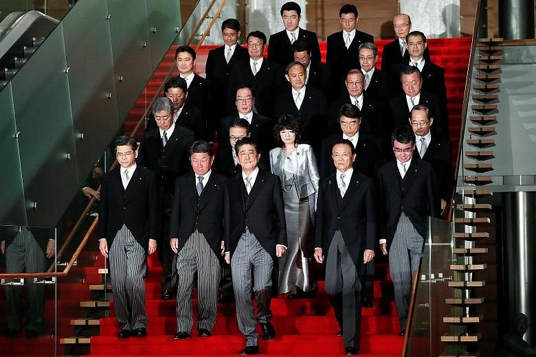 Prime Minister Shinzo Abe (front row, centre) with his Cabinet ministers at his official residence in Tokyo on Tuesday.