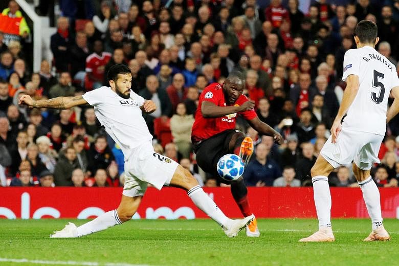 Manchester United's Romelu Lukaku trying to shoot against Valencia's Ezequiel Garay and Gabriel Paulista but to no avail. The Belgium striker was heavily criticised by former United defender Rio Ferdinand following Tuesday's 0-0 Champions League draw
