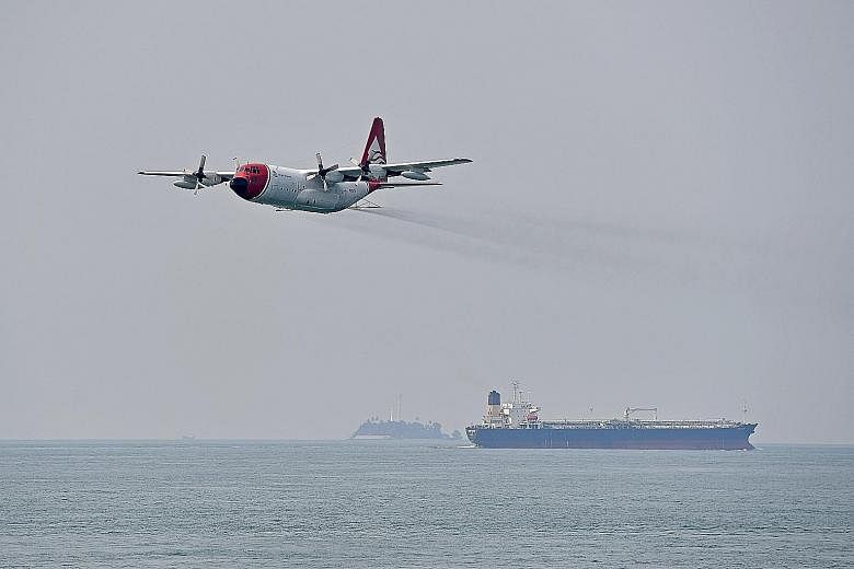 The exercise scenario also required the immediate evacuation of an "injured" crew member on board the damaged tanker. The spill response teams sprayed dispersants from a C-130 aircraft to contain a mock oil spill during the exercise yesterday.