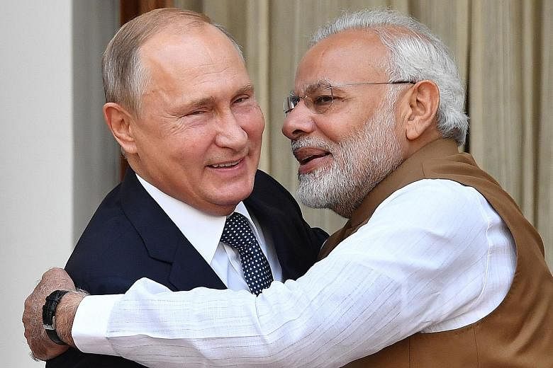 Indian Prime Minister Narendra Modi welcoming Russian President Vladimir Putin in New Delhi yesterday. Under the deal, India will purchase five S-400 Triumf anti-aircraft weapons systems from Russia.
