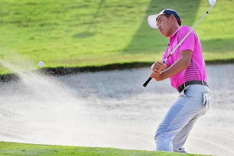 China's Jin Cheng, the 2015 winner, getting out of a bunker yesterday in the second round of the Asia-Pacific Amateur Championship at Sentosa Golf Club.