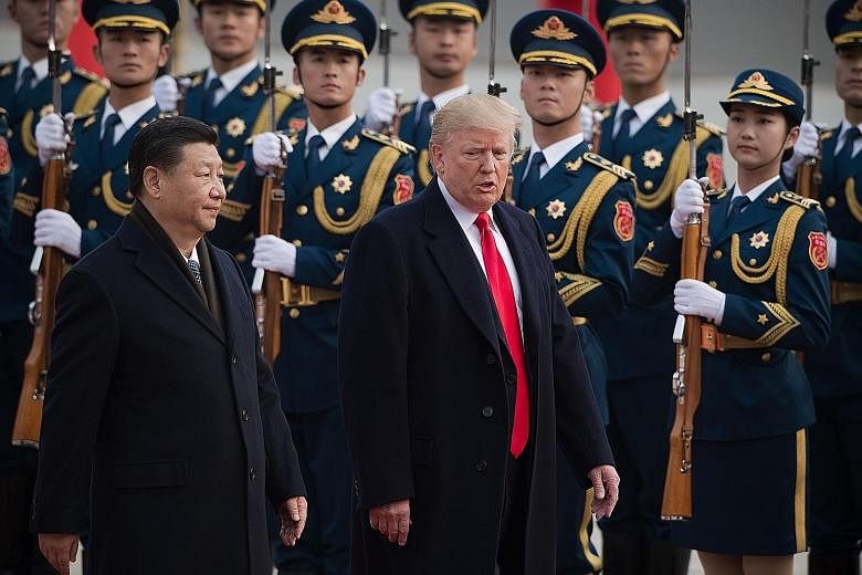Chinese President Xi Jinping with US counterpart Donald Trump in Beijing last November. A new US national cyber strategy unveiled by Mr Trump says "China engaged in cyber-enabled economic espionage and trillions of dollars of intellectual property th