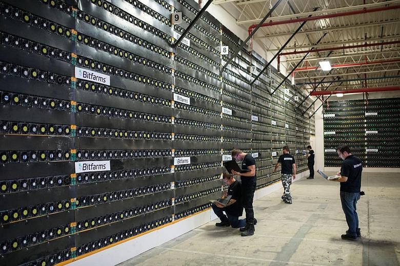 Technicians monitor cryptocurrency mining rigs at a facility in Canada. Acquiring the technology may eventually lead to well-paid and satisfying jobs.