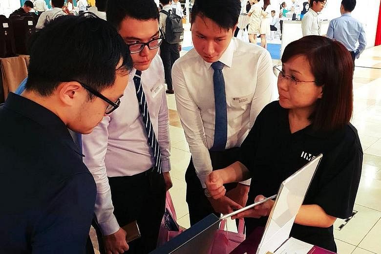 NTU students at the Infocomm Media Development Authority booth during NTUtopia, an invite-only career fair. One undergraduate said organisers had checked resumes and GPAs at the door.