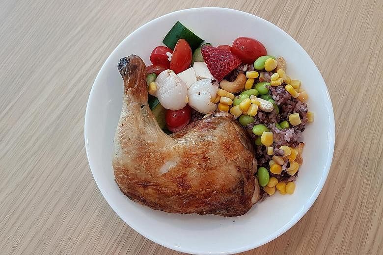 The Totally Nutrition Power With Chicken rice bowl includes a roast chicken leg, organic black, brown and red rice, fruit and vegetables.