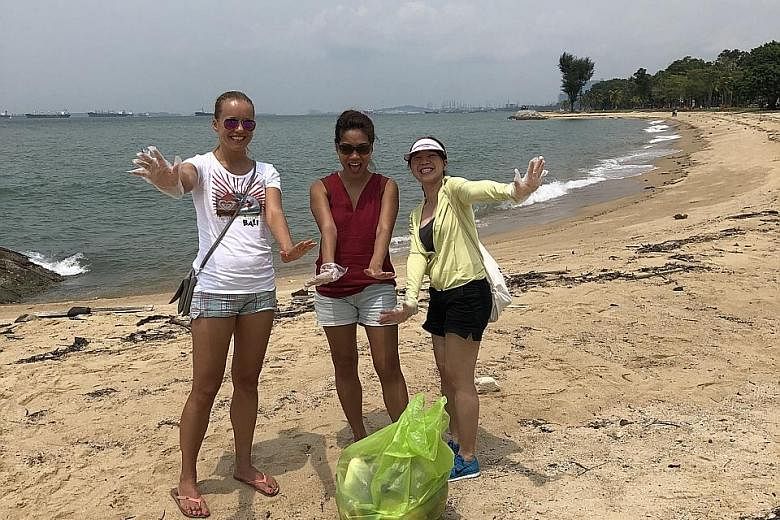 Mr Lee Leong Hui (in front) plogging at the East Coast beach with his colleagues from property firm Lendlease last Thursday, as part of the company's annual community day. The term "plogging" is a mash-up of the word "jogging" and the Swedish words "