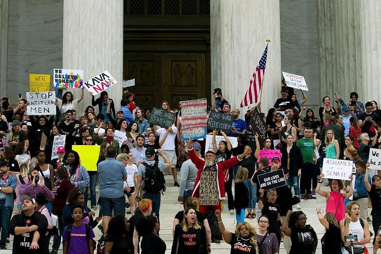 People gathering at the US Supreme Court steps to protest against Mr Brett Kavanaugh's appointment in Washington last Saturday. The writer says the biggest problem with life tenure for Supreme Court justices is that it makes a seat on the Bench far t