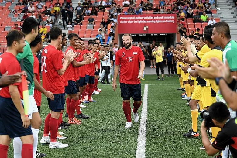 A Singapore All-Stars team and a Tampines Rovers All-Stars team form a guard of honour in welcoming Fahrudin Mustafic onto the field for his testimonial match at Our Tampines Hub last night. He played for Singapore 87 times, scoring eight goals for t