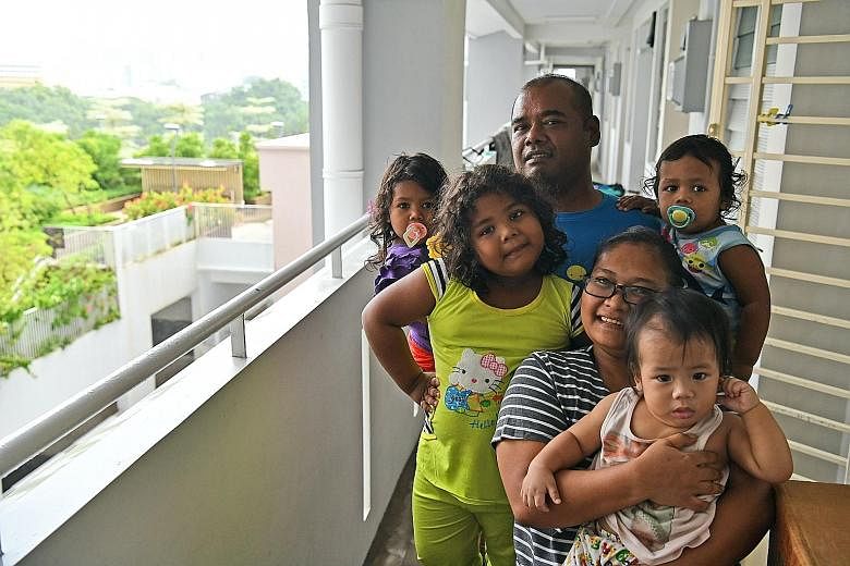 Ms Nuraini Jamalludin with her husband Yusran Asip, 43, and children (clockwise from front) Mohamad Solihan, one, Nur Ar'yani, five, Nur Ar'yana, three, and Mohamad Solihin, two, at their home. ST interviewed 20 residents of rental blocks integrated 
