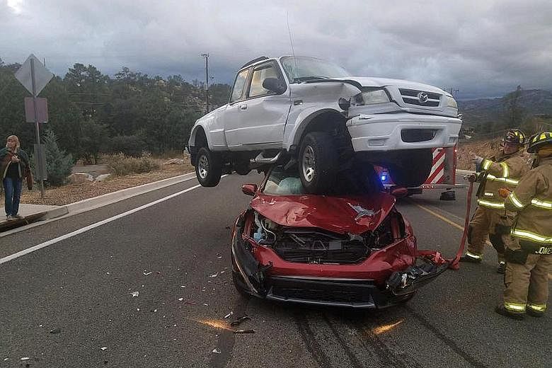 Firefighters in Prescott, Arizona, were surprised to find a white pickup atop a red sedan on Sunday after receiving reports of a three-vehicle accident. Incredibly, no one was injured in the "remarkable crash", as the Prescott Fire Department called 