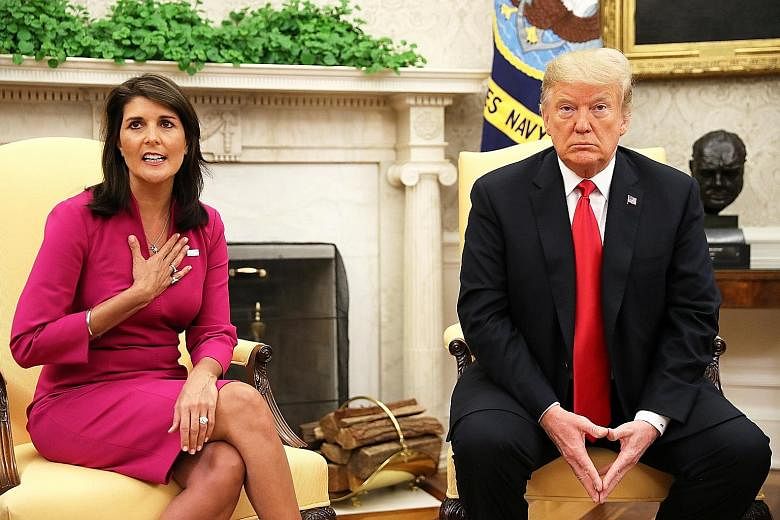 Ms Nikki Haley with US President Donald Trump in the Oval Office yesterday. Ms Haley took the UN envoy job with little experience in foreign policy but quickly became the full-throated voice at the UN for the often unpopular agenda of Mr Trump.