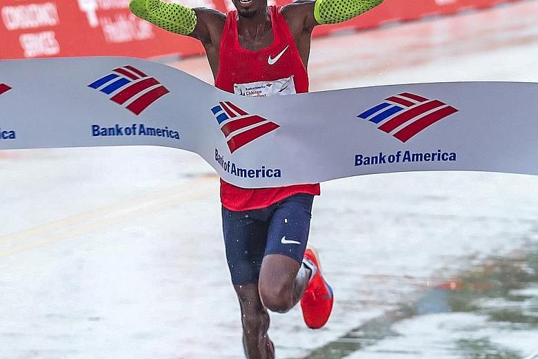 Briton Mo Farah crosses the line to win the 41st Chicago Marathon on Sunday, announcing himself as a threat to world record holder Eliud Kipchoge of Kenya.