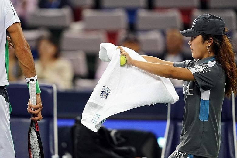 The behaviour of tennis pros towards ball kids such as this girl has come under scrutiny following Fernando Verdasco's rant over a towel at the Shenzhen Open.