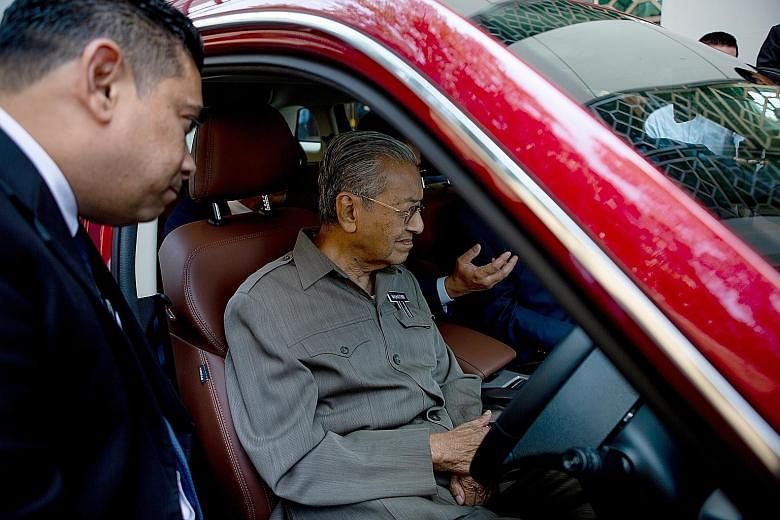 Prime Minister Mahathir Mohamad in a Proton SUV. He started Proton Holdings in the 1980s during his previous tenure, but the brand was later privatised. The new car has been described as competing in a market beyond Malaysia.