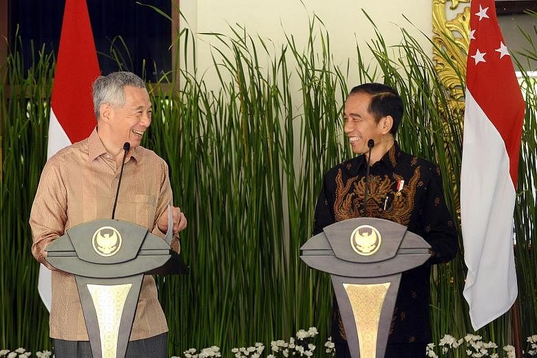 Prime Minister Lee Hsien Loong and Indonesian President Joko Widodo speaking to journalists after their bilateral meeting in Nusa Dua, Bali, yesterday. The leaders noted the mutual trust between the two countries, and said they could do more to benef