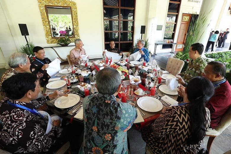 Prime Minister Lee Hsien Loong and Indonesian President Joko Widodo at lunch yesterday at The Laguna Resort in Nusa Dua with (clockwise, from left) Coordinating Minister for Maritime Affairs Luhut Panjaitan, Defence Minister Ng Eng Hen, Coordinating 