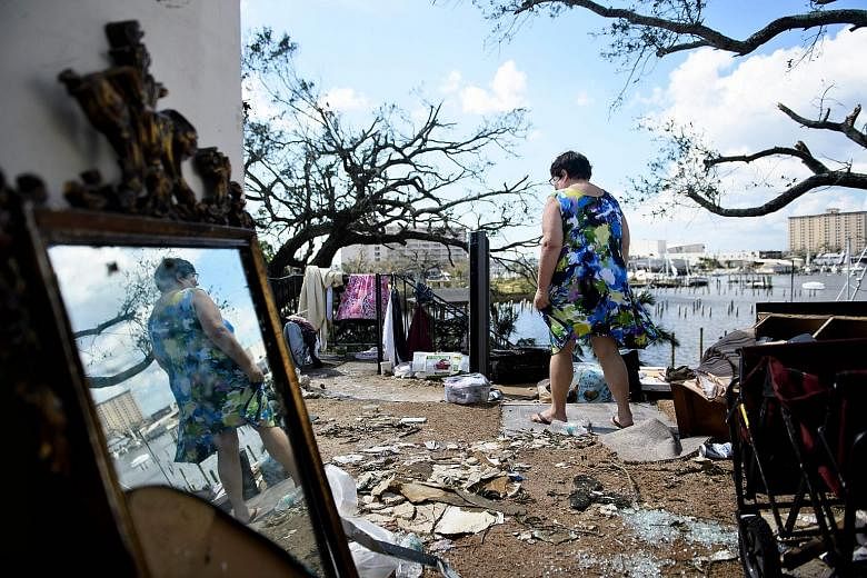 Florida resident Teresa Sheffield walking out of the remains of her apartment in the aftermath of Hurricane Michael on Thursday.