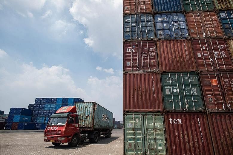 A port in Zhangjiagang in China's Jiangsu province. The International Monetary Fund slashed China's growth forecast for next year to 6.2 per cent from 6.4 per cent.