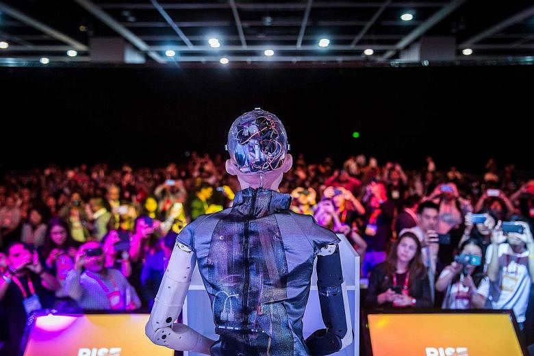 A robot on stage at a technology conference in Hong Kong in July. It is evident that the city relies on China for its economic well-being and to foster tech and innovation. The problem is that China is itself facing a host of problems, says the write