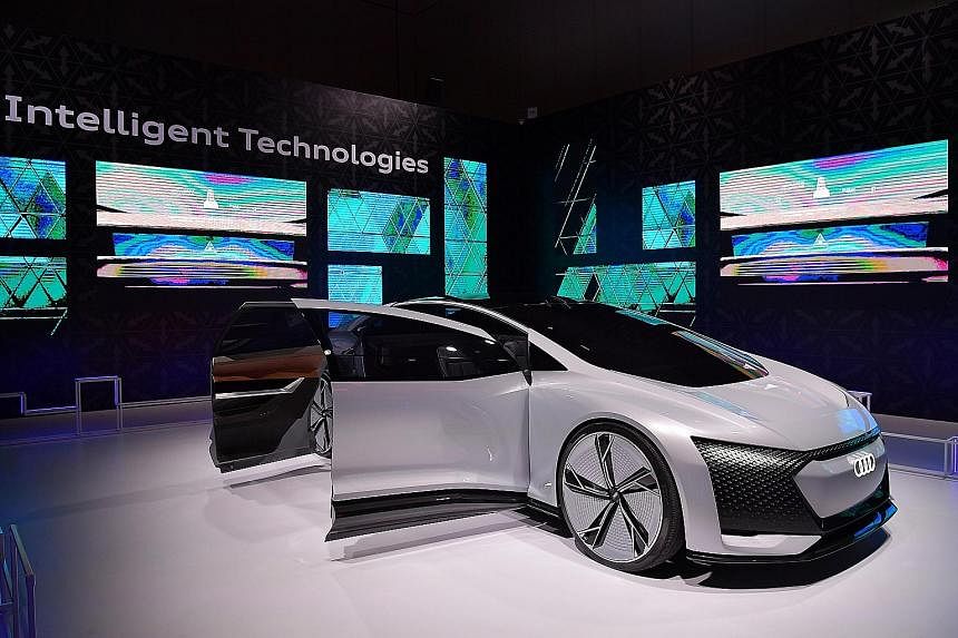 The Audi e-tron will arrive in showrooms by the third quarter of next year. The Audi Aicon (above) concept car is fully autonomous with no steering wheel.