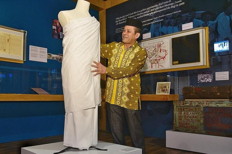 Mr Abdul Halim Mohamed Amin， the former head of haj services with Muis, with the display of his ihram and pelikat sarong, worn by male pilgrims to Mecca, which he donated for the exhibition at the Malay Heritage Centre in Kampong Glam.